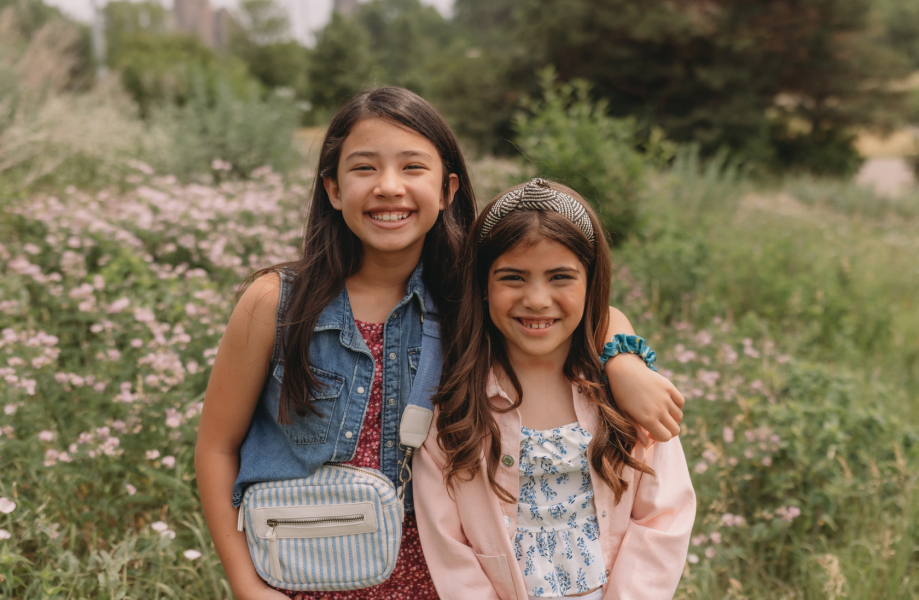 Two girls standing in a field