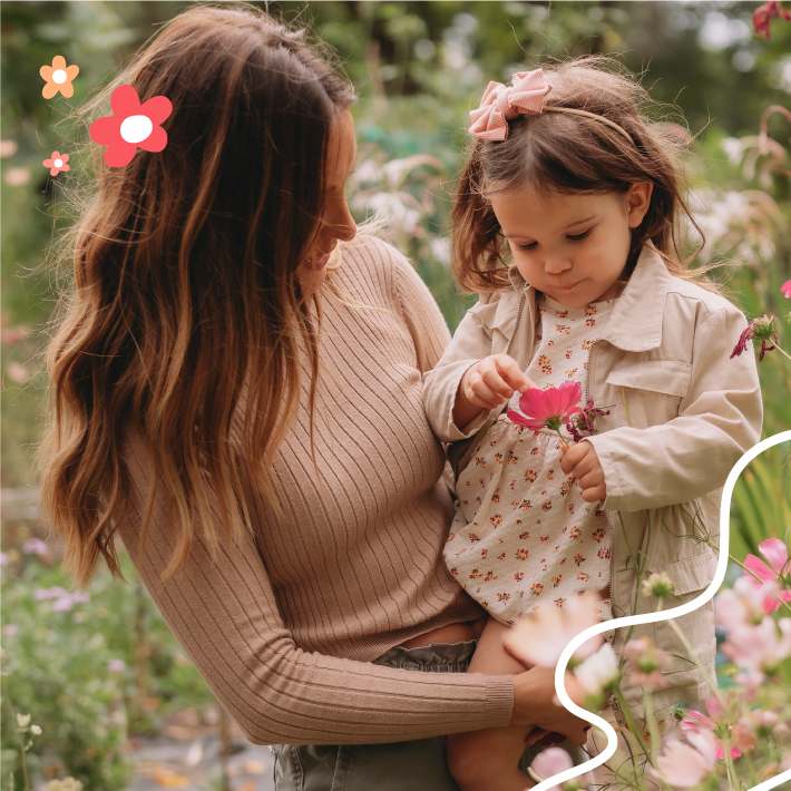 Woman holding baby in spring coat