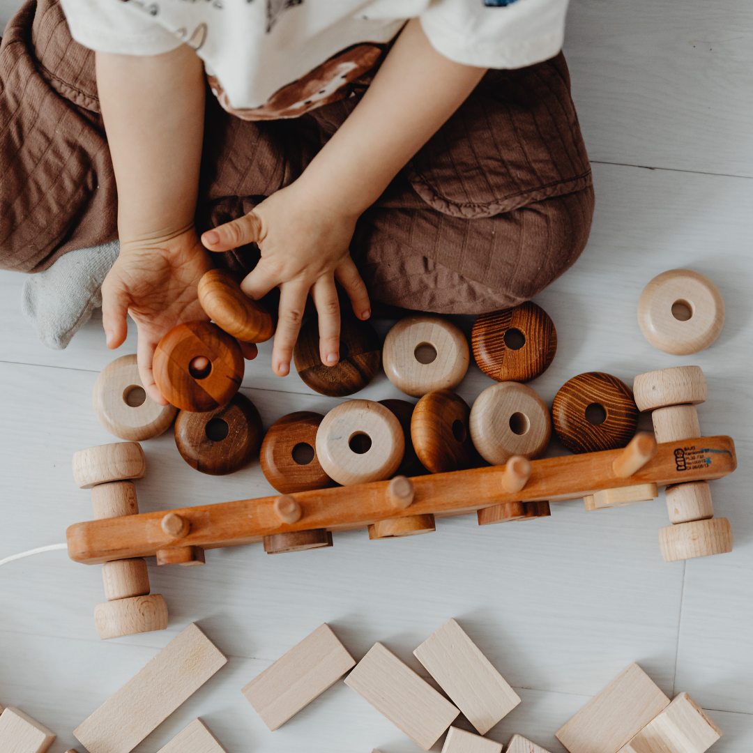 Baby playing with wooden toy