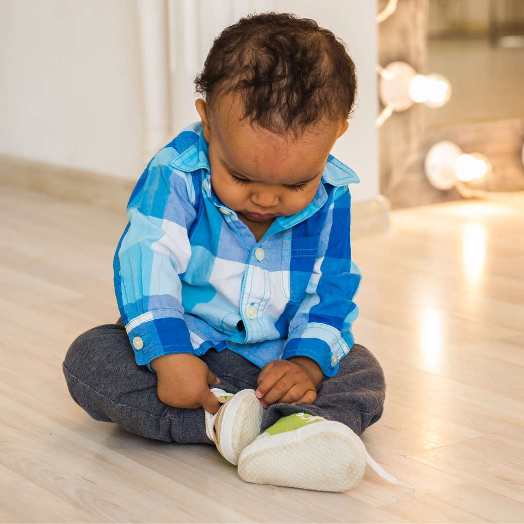 Baby playing with his shoe