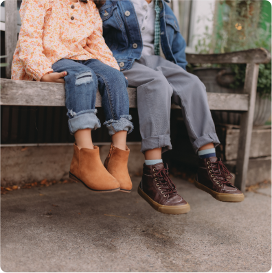 two little kids with their legs dangling