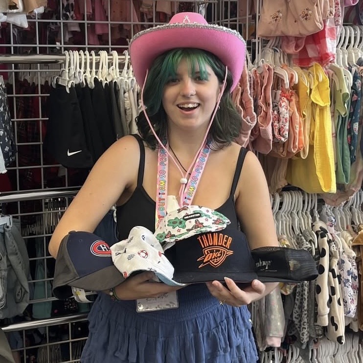 A photo of an employee holding childrens hats