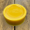 1kg British Beeswax Block, wood background - Honeyfields Bee Farm