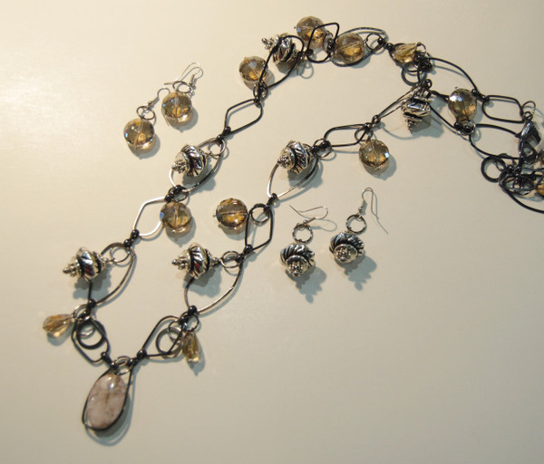 Abstract gun metal chain with silver bobbles and cream hued crystal drops