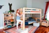 Becks Natural Queen Loft Bed with Daybed Angled View with Teen on Ladder Room