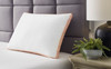 Zephyr 2.0 3-in-1 White and Orange Pillow Ashley Furniture lifestyle image on bed