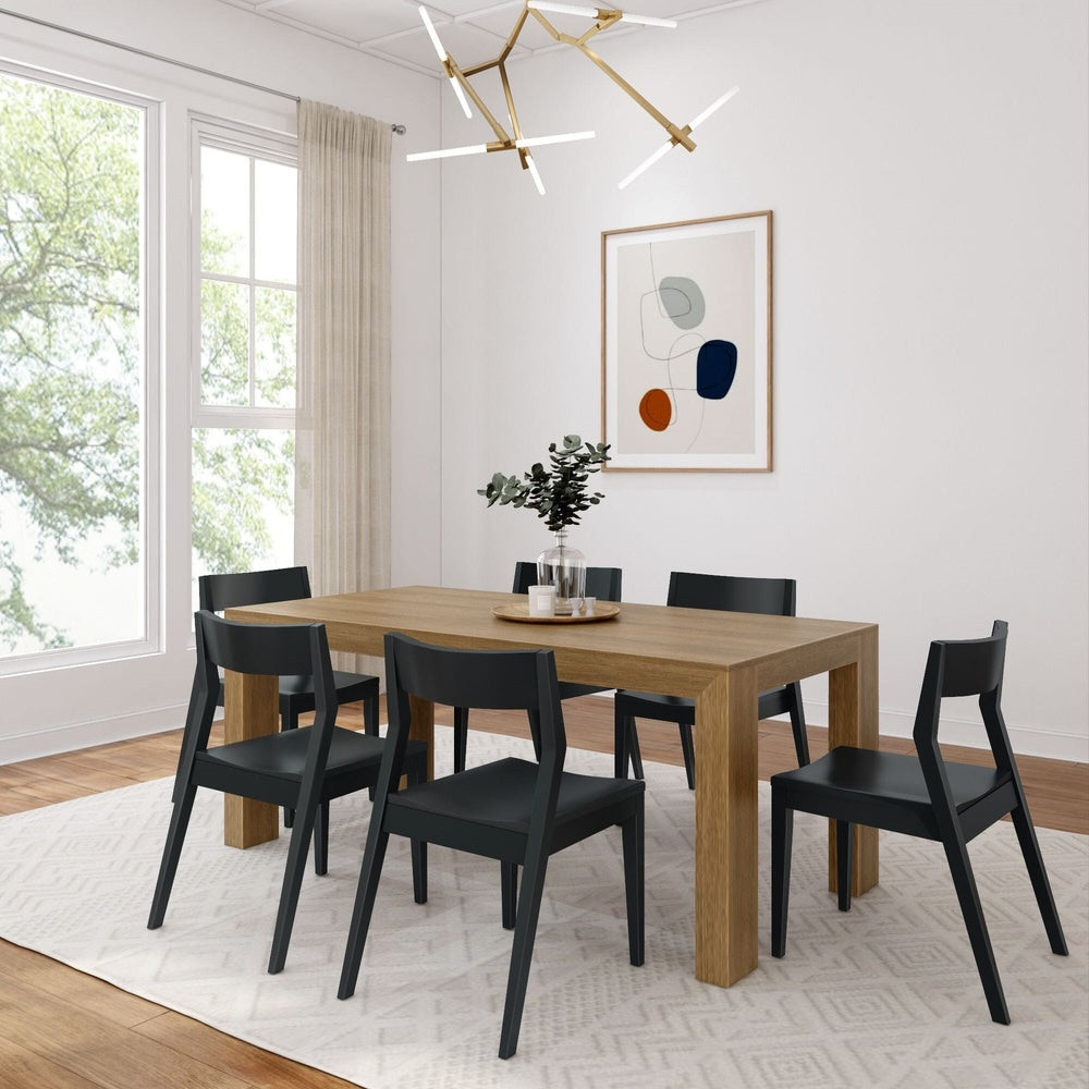 Rockport Distressed Pecan Dining Table Set Angled View shown with Black Chairs Room