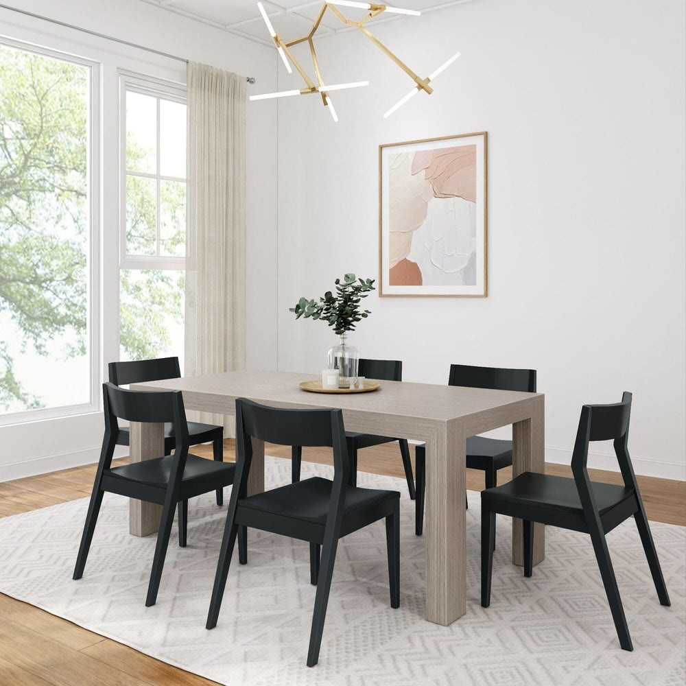 Rockport Distressed Seashell Dining Table Set Angled View shown with Black Chairs Room