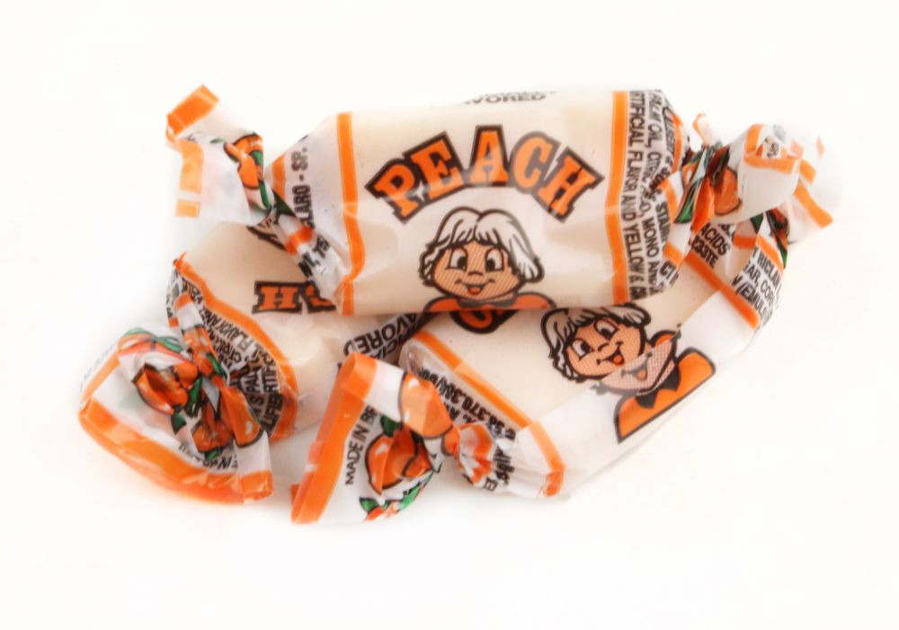 Albert's Peach Chews, 240 individually wrapped, vibrant orange, super chewy peach candy pieces.