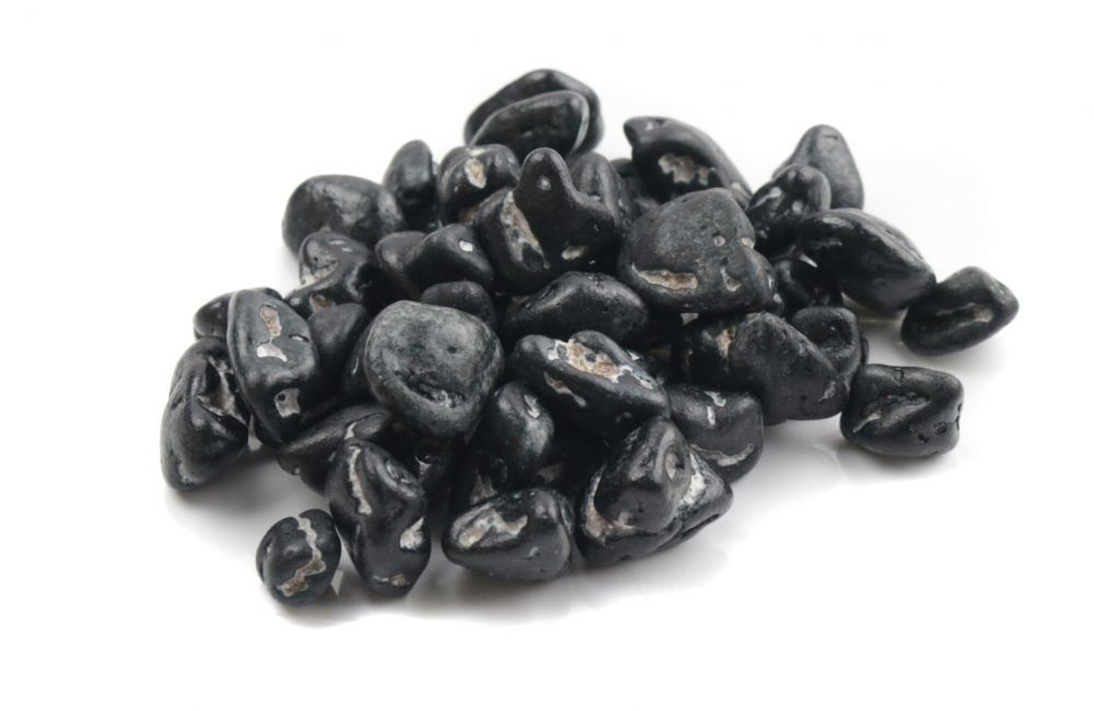 Small, black candy coated milk chocolate coal pieces, a novelty Christmas candy for the naughty list.