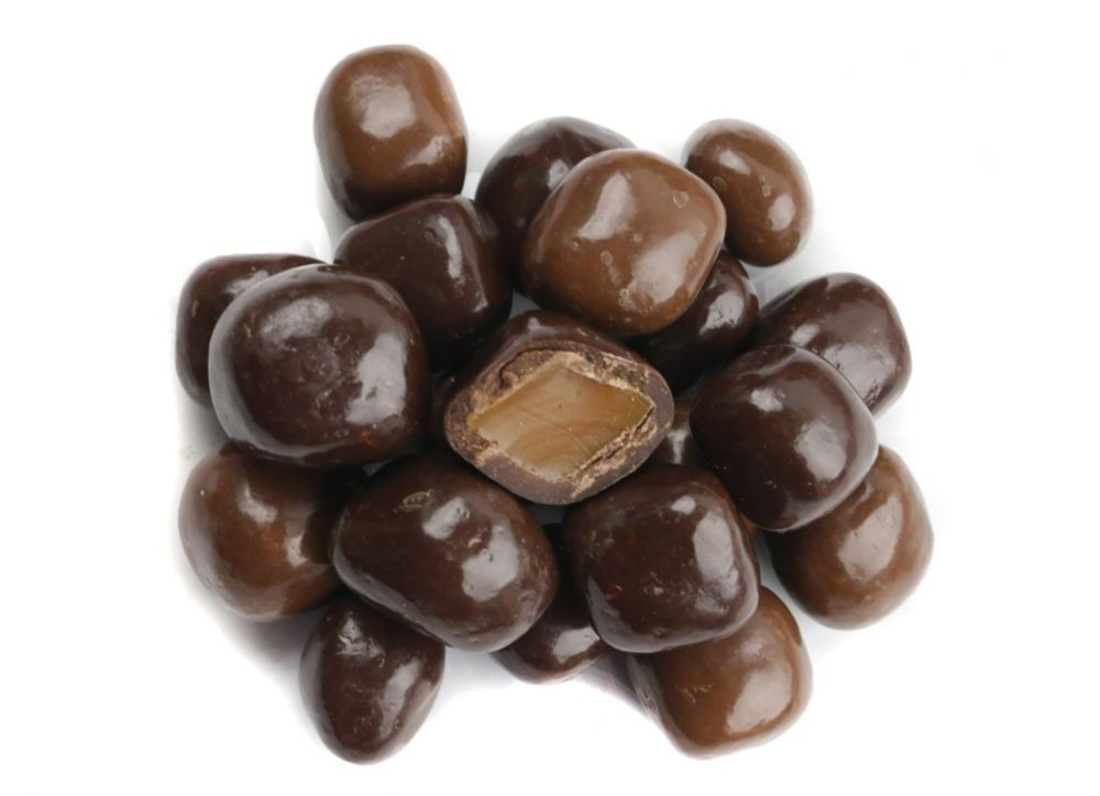 Assorted milk and dark chocolate sea salt caramels, individual bites with visible white sea salt flakes.
