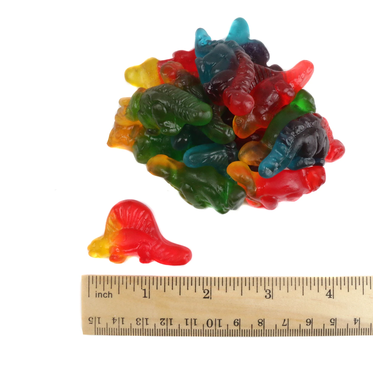 Red, green, yellow gummy dinosaurs, various shapes like brontosaurus, stegosaurus, triceratops. Approx 70 pieces per pound.