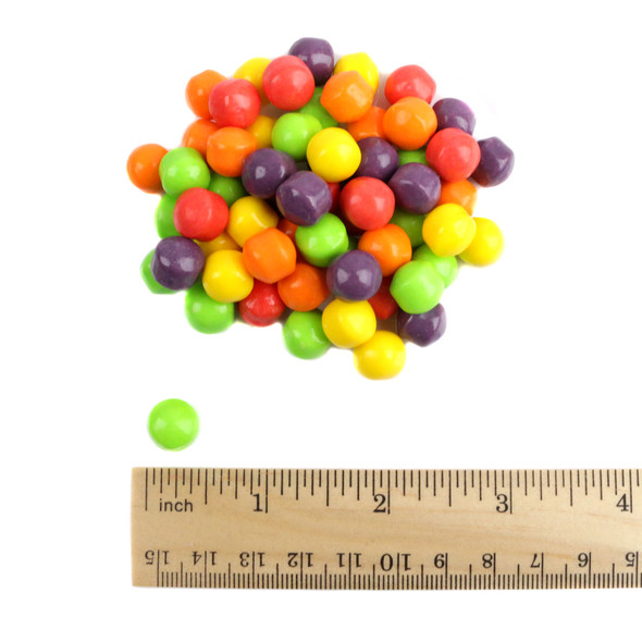 Bulk unwrapped Chewy SweeTarts, mini chewy candies in vibrant rainbow colors, cherry, grape, orange, green apple, lemon flavors.