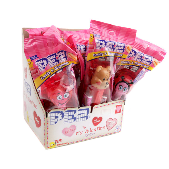 12 Pez Valentine's Day dispensers, individually wrapped with red, pink hearts, and candy refills.