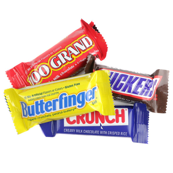 An assortment of individually wrapped fun size chocolate candy bars scattered across a clean white background.
