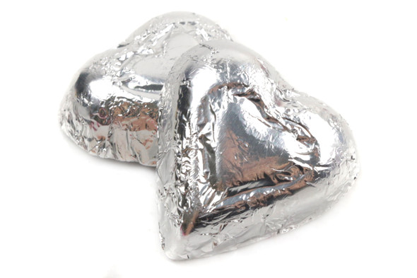 Shiny silver foil wrapped mini milk chocolate hearts, approx 55 per pound, elegant candy buffet, party favors.