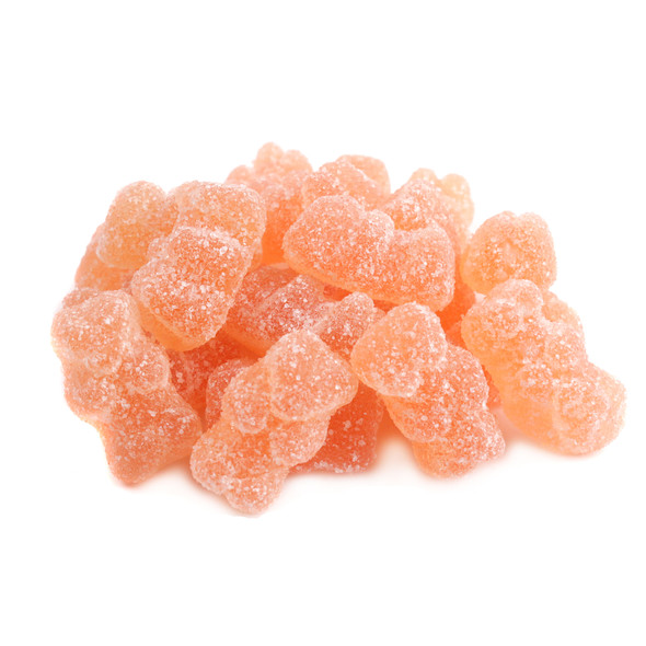 Pile of 130 golden, sugar-dusted Prosecco sour gummy bears, chewy and non-alcoholic.