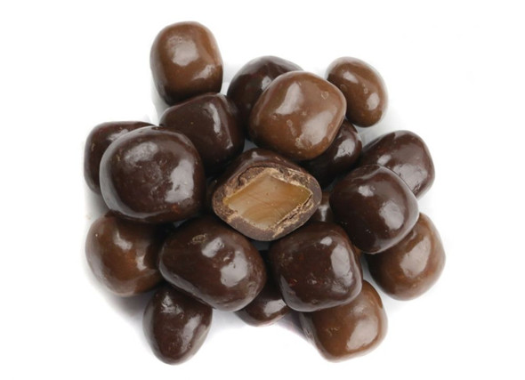 Assorted milk and dark chocolate sea salt caramels, individual bites with visible white sea salt flakes.