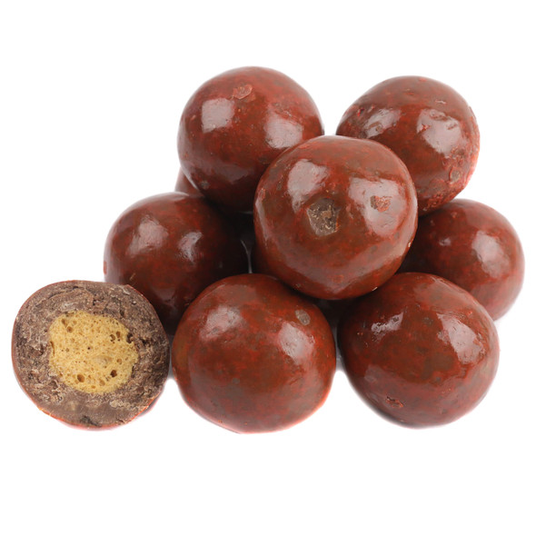 Pumpkin Spice Malt Balls showing off a glossy, burnt orange marbled coating over milk chocolate.