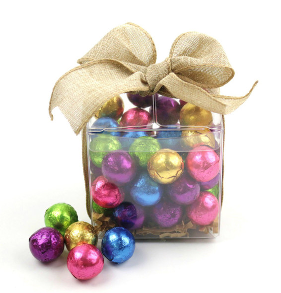 Madelaine 1/2 lb dark chocolate Christmas balls treat cube, vibrantly colored foil wrapped, tied with ribbon bow.