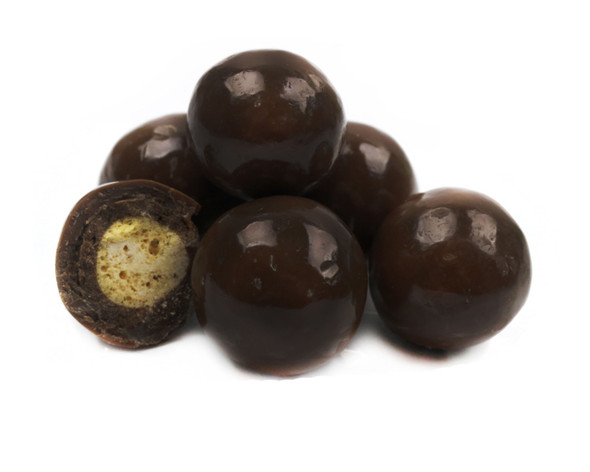 Numerous crunchy, dark brown triple dip malt balls, rich dark chocolate candy made in USA.