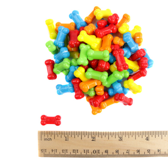 Rainbow-hued pressed candy bones, tiny and tart. Approximately 375 multi-colored Halloween candy bones per pound.