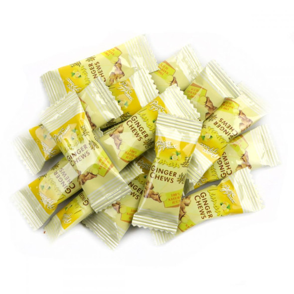 Many vibrant yellow, individually wrapped Ginger Chews, soft, chewy, sweet, and spicy ginger candy.