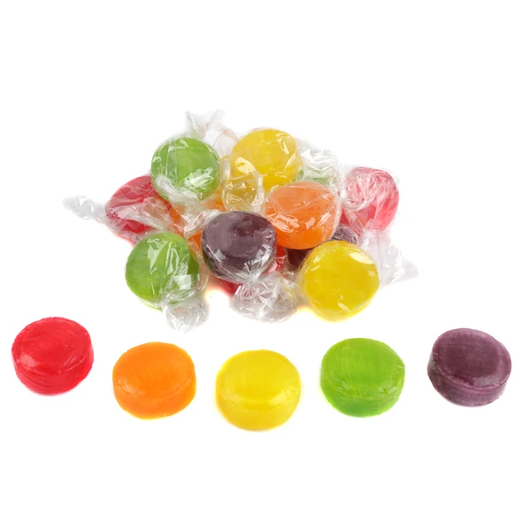 Assorted fruit button hard candies in clear wrappers spread out in bulk