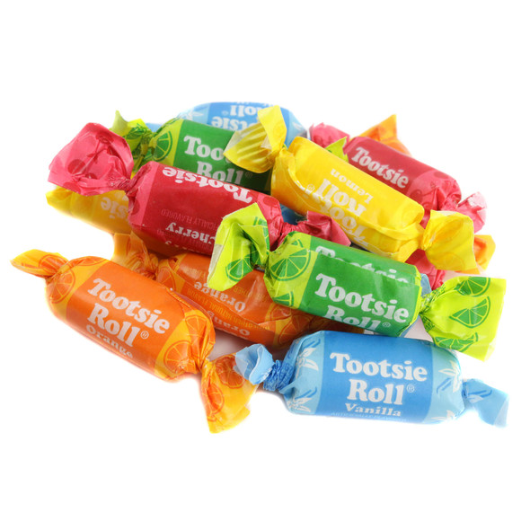 Pile of assorted Flavored Tootsie Rolls, 65+ chewy fruit chews per pound. Vibrant orange, vanilla, lemon, lime, cherry candies.