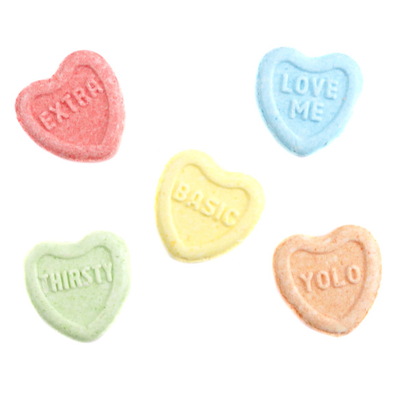 Assortment of bright, multicolored heart-shaped Conversation Hearts, each with a classic romantic saying.