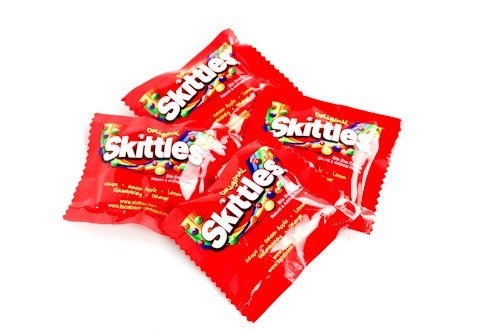 Skittles Fun Size bulk 22lb bag, many small packs of assorted chewy fruity candy. Lime, lemon, grape, strawberry, orange flavors.