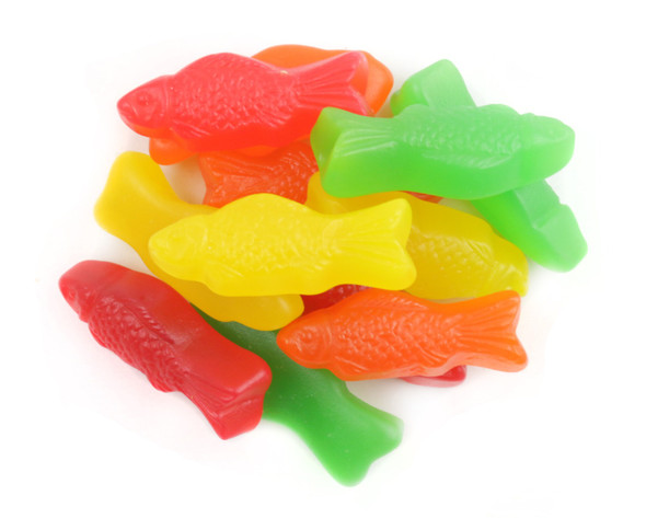31lb box, assorted chewy Juju Fish candy, fish-shaped. Lime, cherry, orange, lemon flavors, vibrant colors.