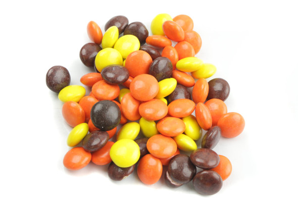 Reese's Pieces 25lb bulk. Smooth peanut butter buttons in yellow, orange, and brown candy shells.