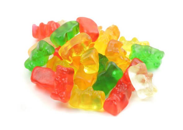 Six 5lb bags of Haribo Gummy Gold Bears, showcasing a vibrant rainbow of red, yellow, pink, and orange fruity candies.