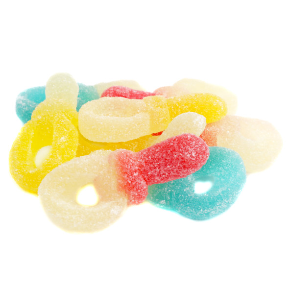 Many vibrant red, yellow, and blue gummy pacifiers, soft chewy candy for bulk assortments.