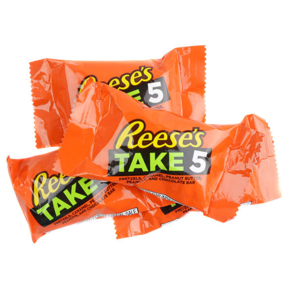 A pile of individually wrapped Reese's Take 5 Fun Size candy bars in their classic bright orange packaging
