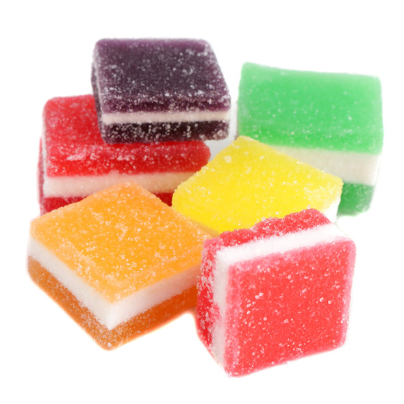 A colorful pile of unwrapped Rainbow Jelly Fruit Bites, showcasing the soft, chewy jelly candies in vibrant purple, green, orange, and red