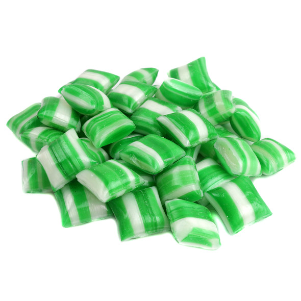 Close-up of hard mint pillow candies with vibrant green and white stripes.