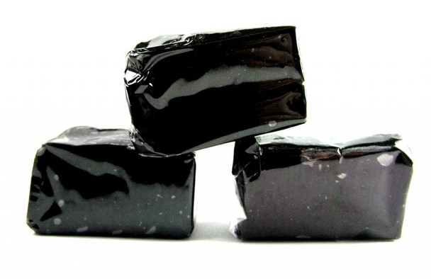 Black Licorice Caramels, individually wrapped in clear cellophane, showing soft texture. Approx 40 pieces per pound.