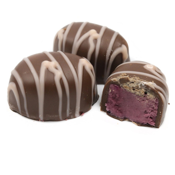 Ashers Milk Chocolate Raspberry Creams, approx 25 dark brown chocolates with pink raspberry cream filling.