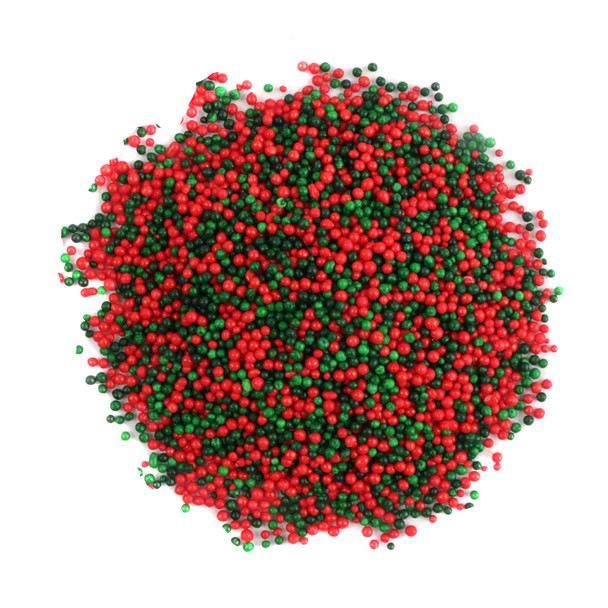 Vibrant red and green nonpareil sprinkles, countless tiny round candies by Sprinkle King for festive Christmas baking.