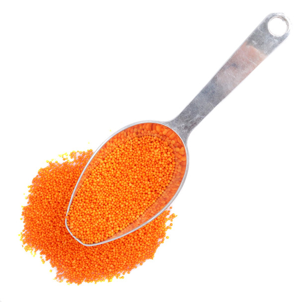 Scooping bulk orange nonpareil sprinkles for holiday, Halloween, and fall baking recipes.