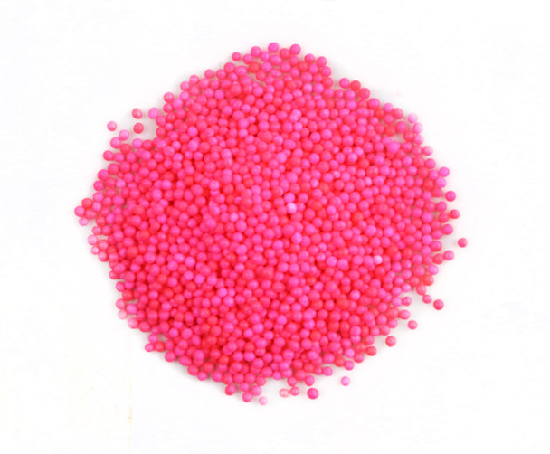 Bright pink nonpareil sprinkles, tiny crunchy confectionery balls for decorating cakes, cupcakes, cookies, baby shower treats.