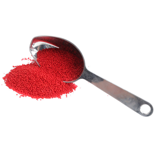 Bright red nonpareil sprinkles, small round candies, ideal for baking, dessert toppings, frosting, and decorating sweet treats.