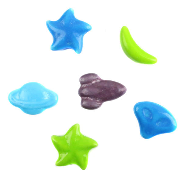 A close-up view of space-themed Concord pressed sugar candies featuring alien heads, rockets, stars, moons, and planet shapes