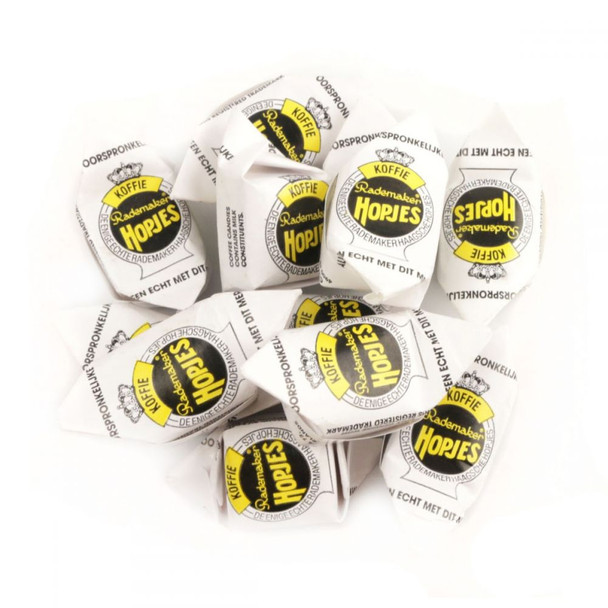 A pile of brown and amber Hopjes Coffee Candies, Dutch hard candy, with coffee and caramel flavor, about 100 pieces.