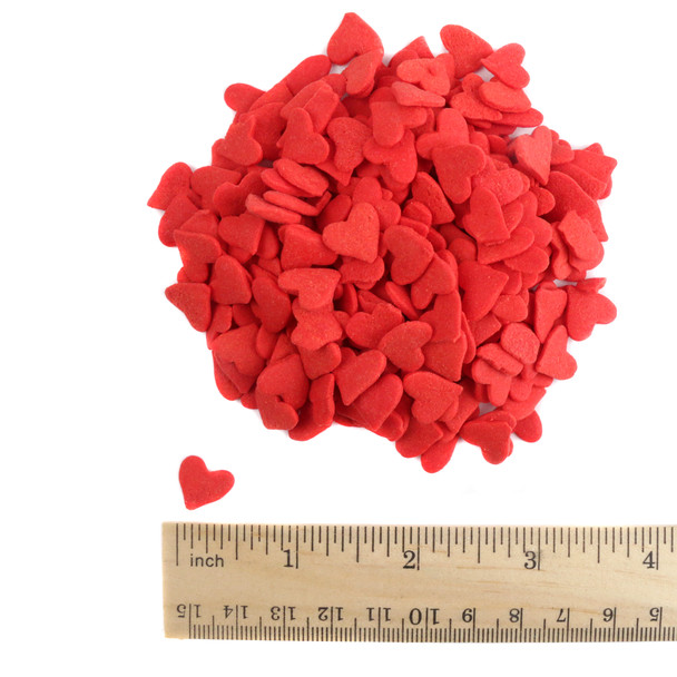 Red heart shaped sprinkles, approximately 1/4 inch, for decorating desserts like cupcakes and cookies.