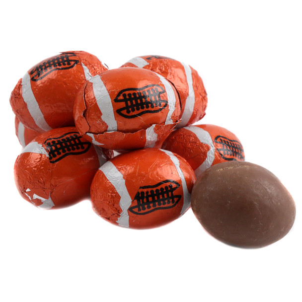 Madelaine milk chocolate footballs, dark orange foil wrapped, approximately 65 per pound.