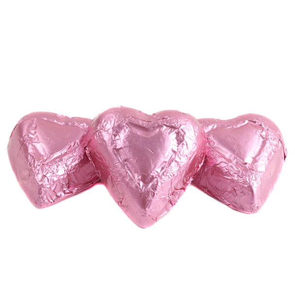 Pink mini milk chocolate hearts, individually foil-wrapped. Approx 55 hearts per pound, pastel pink. Madelaine Chocolate.