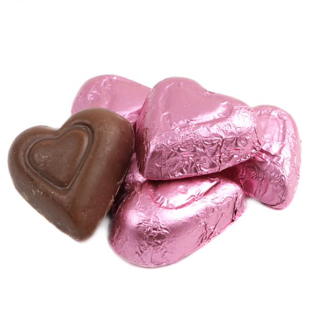 Elegant pastel pink foil-wrapped Madelaine mini milk chocolate hearts, approx. 55 per pound.